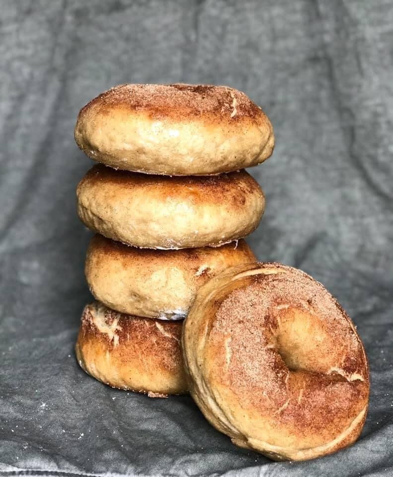 A stack of French-toast sourdough bagels dusted with cinnamon sugar
